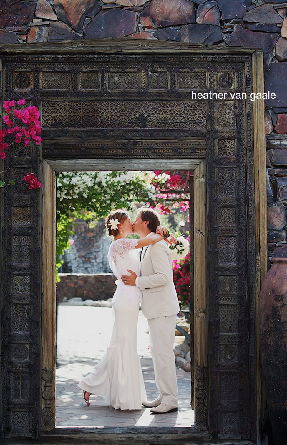 bride and groom kiss rustic korakia